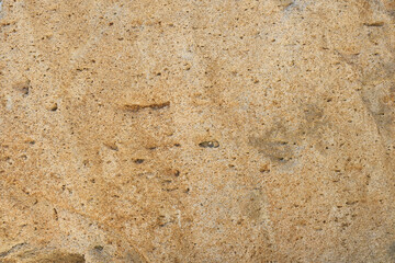 表面に凸凹のある茶色い石のクローズアップ。石や岩のテクスチャー