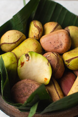 Overhead view of kola nut on leaf, top view of fresh kolanut