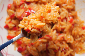Savory Rice With Vegetables On Spoon. Fresh, Warm Home-Cooked Meal Close-Up