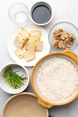 Overhead view of mise en place of ingredients for making vegan claypot rice, top view of ingredients for making claypot rice