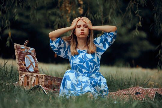 Stressed Woman at a Picnic in Nature Forgetting the Food. Perfectionist lady making a mistake in organizing a picnic
