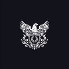 Vintage heraldic logo design featuring a majestic eagle with outstretched wings above a shield and laurel wreath
