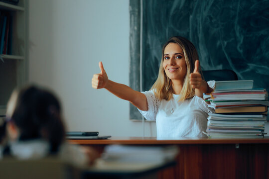 Happy Teacher Showing Thumbs Up in Evaluation process. Professor giving a positive feedback for kids in classroom 