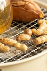 Roasting Peanuts and Sweet Potato on a Grill, stock photo