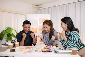 UX/UI designers collaborating during a creative workshop to test interface ideas and exchange feedback for app development, emphasizing teamwork and innovative design thinking.