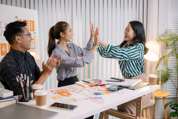 UX/UI designers collaborating during a creative workshop to test interface ideas and exchange feedback for app development, emphasizing teamwork and innovative design thinking.