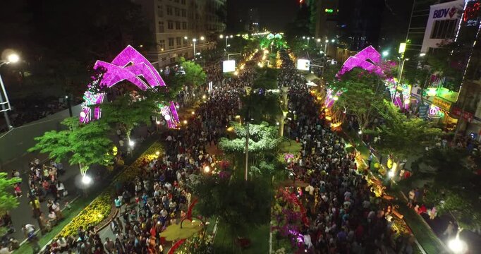 Vibrant Ho Chi Minh City Festival Night with Crowds and Illuminated Arches