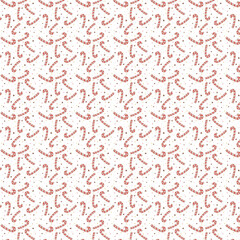 Playful seamless pattern with red and white candy canes and tiny confetti dots on a white background, perfect for Christmas themes.