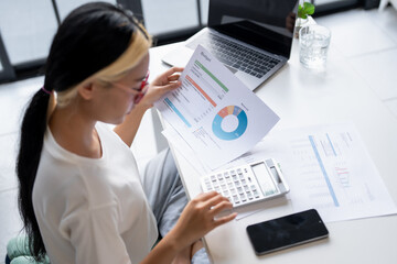 Asian Woman Managing Finances pay Bills and Budget financial at home.