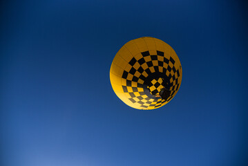Hot Air Balloon Festival with Yellow Balloon in Blue Sky