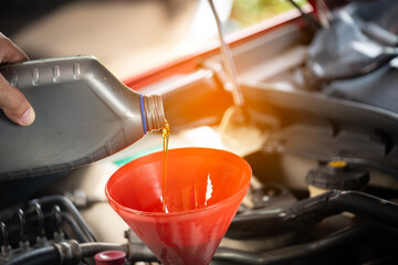 Refueling and pouring oil quality into the engine motor car Transmission and Maintenance Gear...