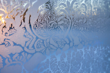 Frost fern ice pattern winter window frozen glass delicate crystal morning light abstract nature cold texture blue tone sunrise glow whisper softly across frost fern ice pattern winter window