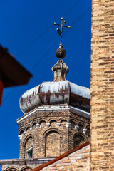 Close-up of the ancient brick bell tower (campanile) of a historic church in Murano, Italy,...