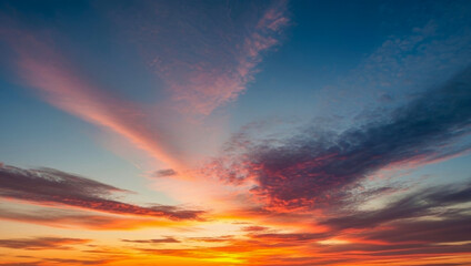 Sky at sunset with colorful clouds in shades of orange, pink, and blue, glowing softly above the horizon, evoking warmth, beauty, and a calm, peaceful evening mood.