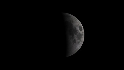 Half illuminated moon in dark black space showing craters and surface details night © Motion  Grid