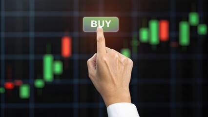 A hand pressing a "BUY" button in front of a stock market chart with green and red candlestick indicators.