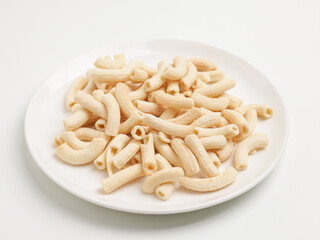 Crunchy macaroni snacks, piled on white background