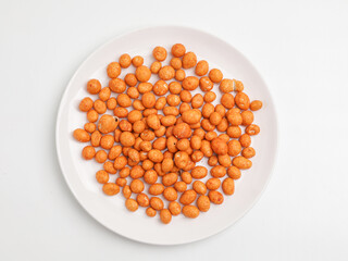 Flour coated peanuts on white background