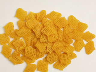 Raw crackers, piled on white background