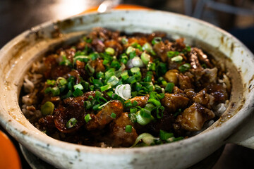 Close-up Chicken Clay Pot Garnished With Green Onions