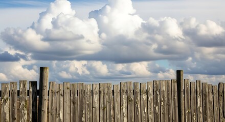 Rustic wooden fence under a cloudy sky