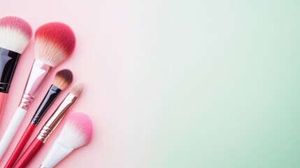 A set of neatly arranged professional makeup brushes featuring different sizes and shapes on a soft green backdrop. Ideal for makeup lovers looking for high-quality tools