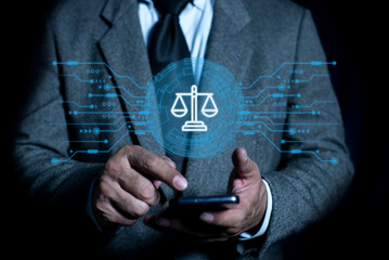 Businessman touching smartphone with law technology symbol on virtual screen. Justice and laws concept. Attorney at law legal business advice lawyer. AI ethics or AI law.