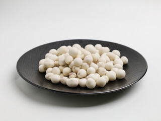 Flour coated peanuts on white background