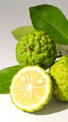 Fototapeta premium Bergamot Citrus - Aromatic Fruit with Green Leaves and Cross-Section.
