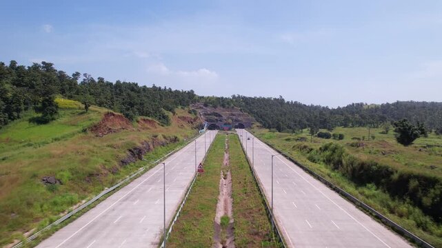 Tunnels on Igatpuri Kasara section of Samruddhi Mahamarg expressway construction over a forest area connecting Mumbai and Nagpur, Maharashtra, Establishing drone shot