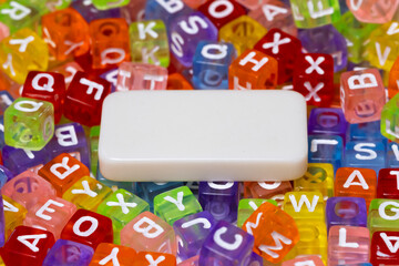 White copy space block between colorful glossy alphabet cubes. Younger kids educational concept.