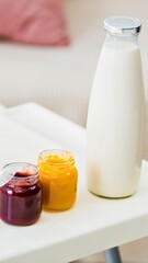 Homemade baby food and fresh milk in jars and bottle