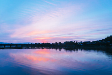 Sunset over River Skyline – Tranquil Cityscape Photography
