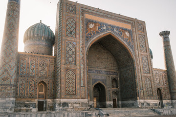 Detailed view of the Sher-Dor Madrasah dome in Samarkand, Uzbekistan. The elegant blue tiles and Kufic inscriptions showcase the beauty of Central Asian Islamic art.