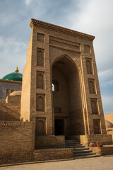 Fototapeta premium Facade of the Kalyan Mosque in Bukhara, Uzbekistan. Majestic brick portal of the Po-i-Kalyan complex under a soft afternoon light.