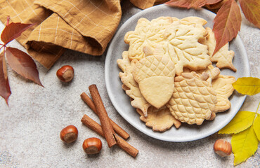 Autumn cookies on plate with cinnamon and hazelnuts