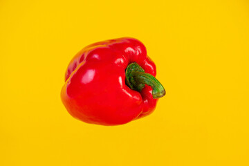 Red,yellow and green sweet peppers on yellow background