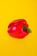Red,yellow and green sweet peppers on yellow background