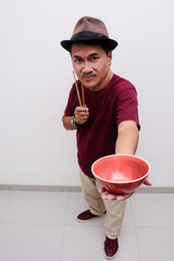 Man holding red bowl to offer delicious Chinese food