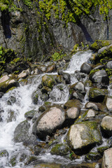 River water flowing through large rocks
