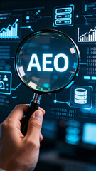 Hand holding magnifying glass over AEO text on digital data interface