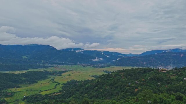 Aerial view of lush green paddy fields in Tansen Palpa, Nepal, surrounded by beautiful mountains and rural landscapes, showcasing the region&rsquo;s rich agriculture and natural beauty.