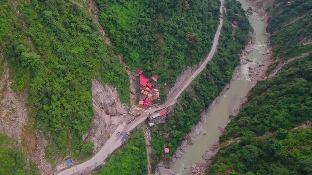 Aerial drone footage of the famous Siddhababa Temple in Tansen Palpa, Nepal, located on a scenic hillside with winding mountain roads and stunning natural surroundings.