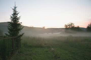 A village at sunset in the fog