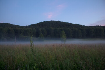 A village at sunset in the fog