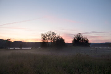 A village at sunset in the fog