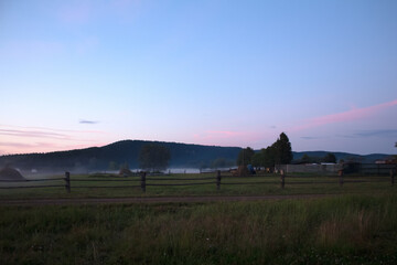 A village at sunset in the fog