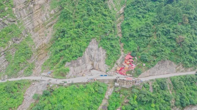 Aerial drone footage of the famous Siddhababa Temple in Tansen Palpa, Nepal, located on a scenic hillside with winding mountain roads and stunning natural surroundings.
