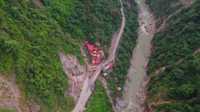 Aerial drone footage of the famous Siddhababa Temple in Tansen Palpa, Nepal, located on a scenic hillside with winding mountain roads and stunning natural surroundings.