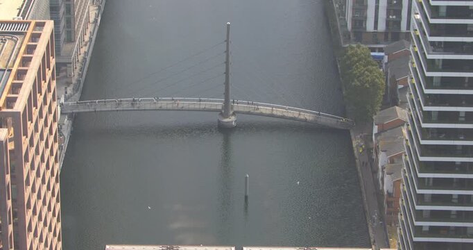 Canary Wharf DLR Train Over Water in London by Day Near One Canada Square.